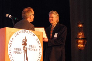Marshall Helmberger is presented with a 2013 Friend of Minnesota Newspapers Award