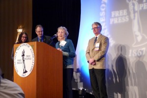 Norma Finnegan accepts the 2013 Distinguished Service to Journalism Award along with her family